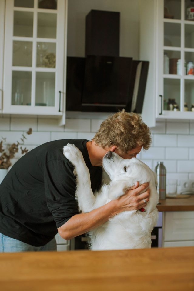 dog and man in an embrace, because love is mutual
