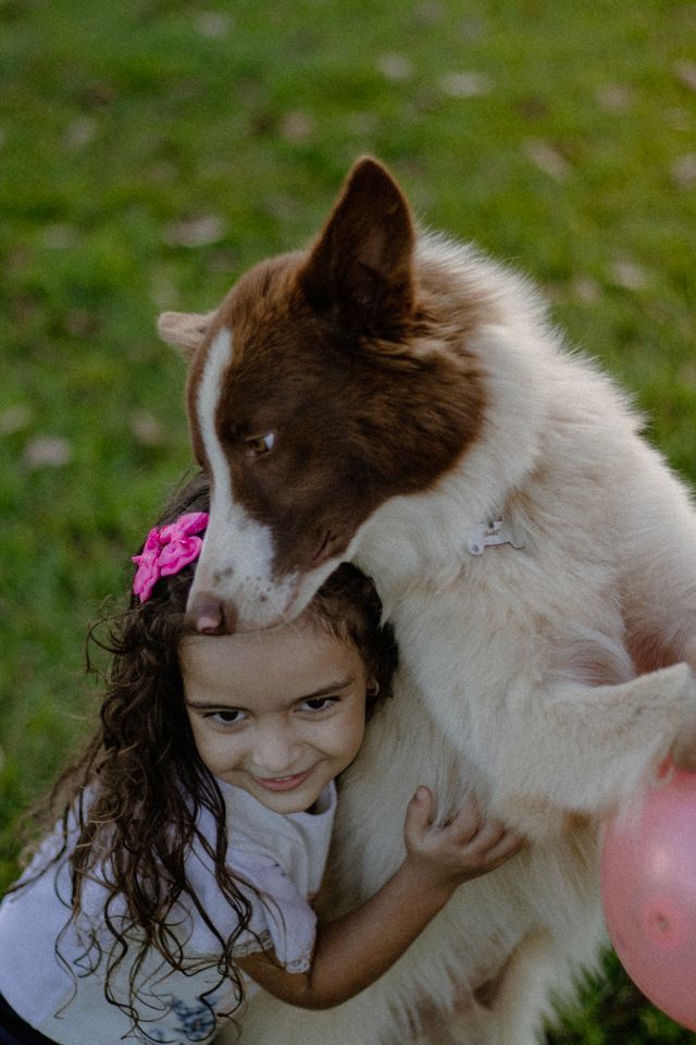 The big dog is the protector of the little girl and her family.