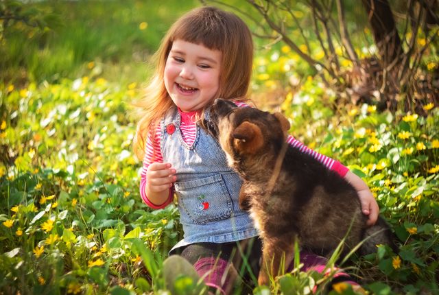 Puppy licking his little girl