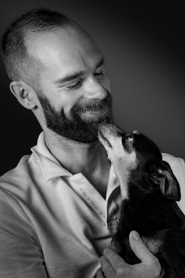 Close-up of a dog licking its owner's hand